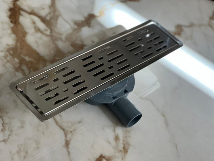 shower-drain-with-a-perforated-face-and-an-external-steel-letter--40-cm
