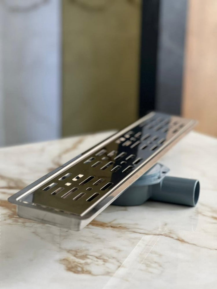 shower-drain-with-a-perforated-face-and-an-external-steel-letter--60-cm