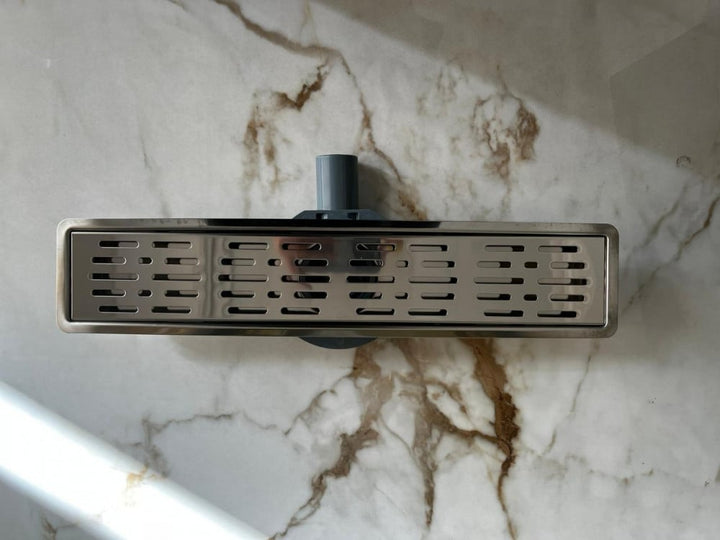 shower-drain-with-a-hollow-face-and-an-external-steel-letter--50-cm