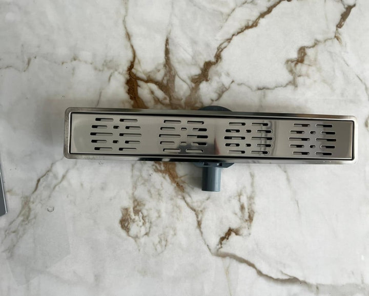 shower-drain-with-a-perforated-face-and-an-external-steel-letter--60-cm