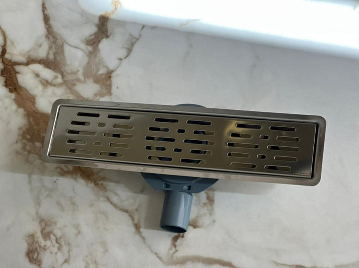 shower-drain-with-a-perforated-face-and-an-external-steel-letter--40-cm